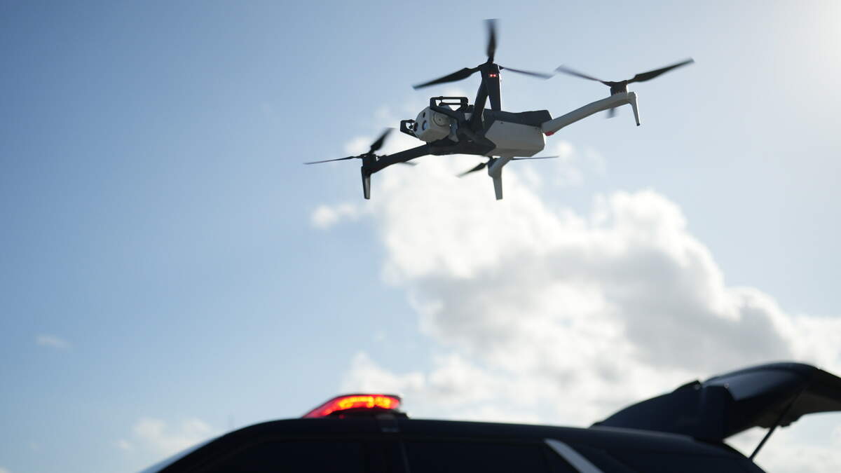 A Skydio X10 drone flies over a police patrol vehicle. The Sacramento Police Department is looking to buy eight of the drones as part of a 52-drone purchase. 